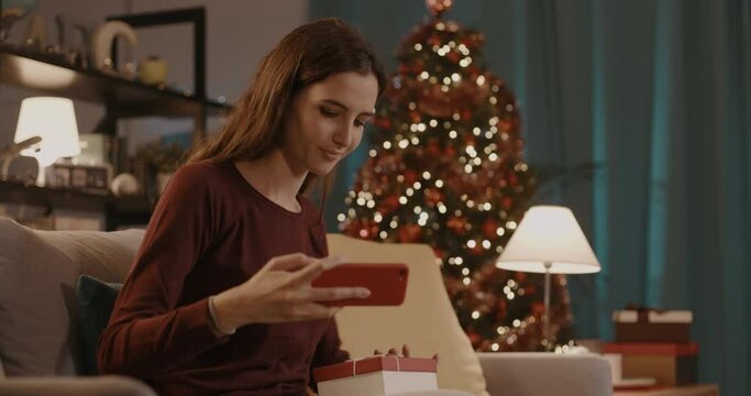 Happy woman taking a selfie with her Christmas gift