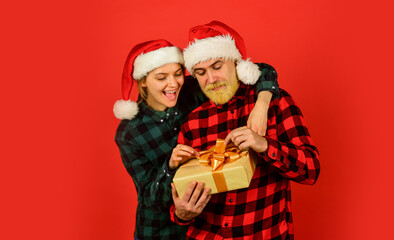 Couple in love with gift. Christmas time. Man and woman christmas holiday celebration. Giving present. Love and care. Spread love. Family shopping. Surprise for spouse. Buy present. Christmas party