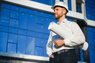 Industrial theme: constructor standing at a site area.