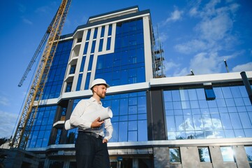 construction worker or architect in construction site outdoors with Hot weather sunny . builder in hard hat inspecting and working in workplace