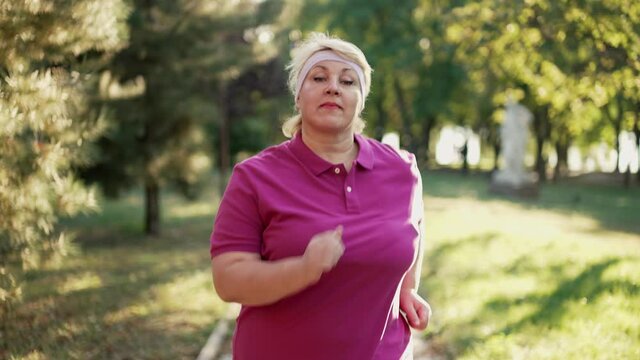 Fat woman runs at the park