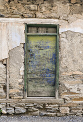 Old wooden door in a mountain village near Barcelonette in the Alps.