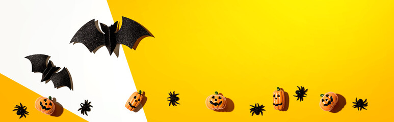 Halloween paper bats and small pumpkin ghosts - flat lay