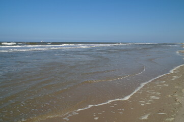 The picturesque North Sea with an endless shoreline with not a single person in view and the blue skies in Baltrum, Germany	