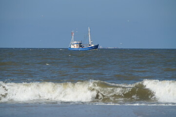 A blue fishing cutter in the North Sea in Germany