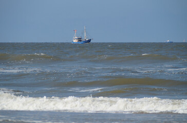 A blue fishing cutter in the North Sea in Germany