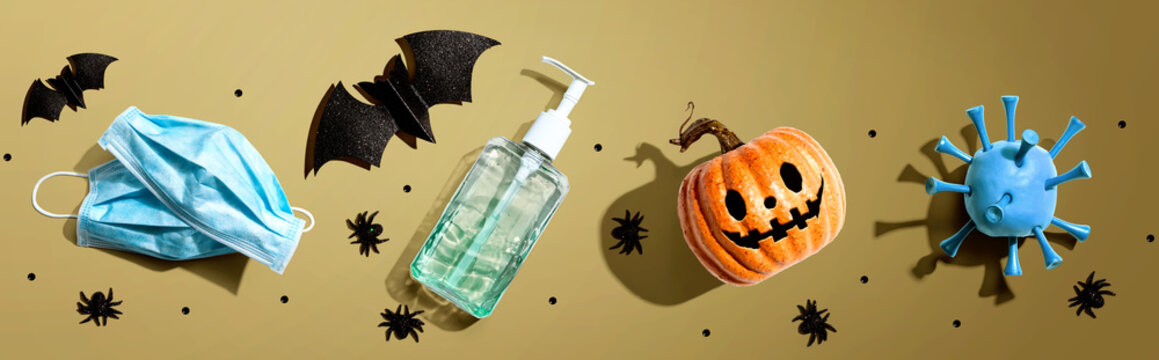 Masks and sanitizer bottle with Halloween objects - healthcare and hygiene concept