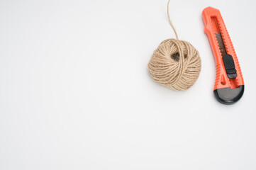Closeup of a stationary knife and a yarn ball isolated on a whit