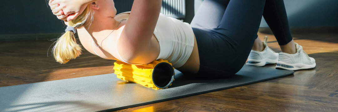 Myofascial release massage Fitness, fit, Girl engaged in stretching fascia by fitness gym. Wellness, health care, lifestyle, generation sports recreation concept with roller for myofascial release
