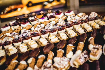 Chocolate and cream pastry dessert plate with cakes and sweets.