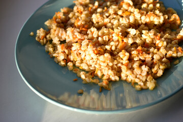 Boiled pearl barley with spices on a plate