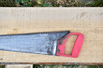 Hand saw on wood on a piece of wood