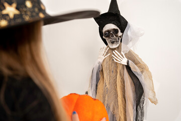halloween holiday. Hanging skeleton in clothes and hat