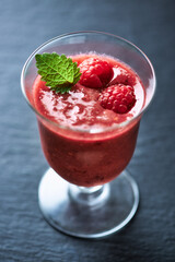 Fresh smoothie in a glass. Dark background. Close up. 