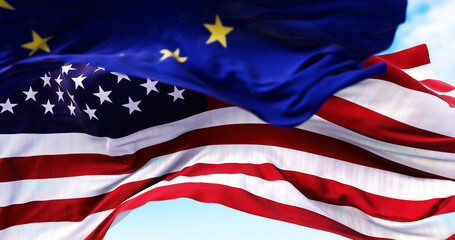 The national flag of the United states of America waving in the wind with the European Union flag