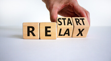 Relax and restart symbol. Businessman turns cubes and changes the word 'relax' to 'restart'....