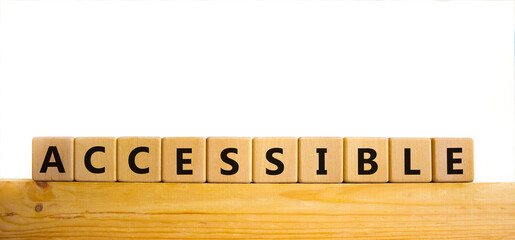 Accessible symbol. The word accessible on wooden cubes. Beautiful wooden table, white background. Business and accessible concept. Copy space.