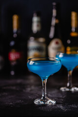 Blue cocktail / wine / champagne on a dark table