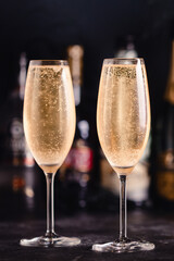 Champagne glasses on a dark background.