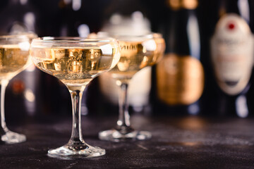 Champagne glasses on a dark background.