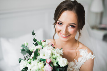 Luxury wedding bride, girl posing and smiling with bouquet