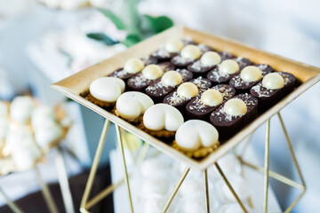 Delicious sweets on wedding candy buffet with desserts, cupcakes