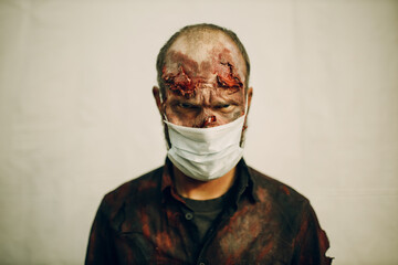 Zombie male makeup wearing medical face mask covering protection halloween party concept.