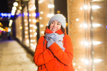 Girl in a night city snowflake Christmas city lights. Christmas and winter holidays concept.
