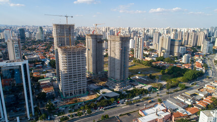 Obraz premium Aerial drone view of the Brooklin neighborhood in São Paulo, Brazil. Four tall buildings under construction