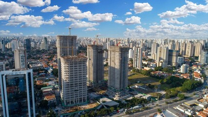 Fototapeta premium Aerial drone view of the Brooklin neighborhood in São Paulo, Brazil. Four tall buildings under construction