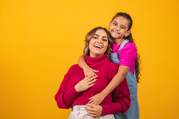 Photo of a beautiful young mommy holding her arms hugging her little daughter good mood adorable...