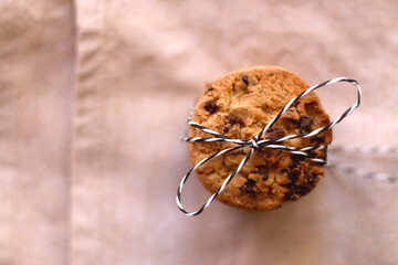 Stack of chocolate chip cookies, tied with ribbon. Top view.
