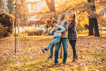 Fototapeta premium Portrait of a happy family having fun in the autumn park.