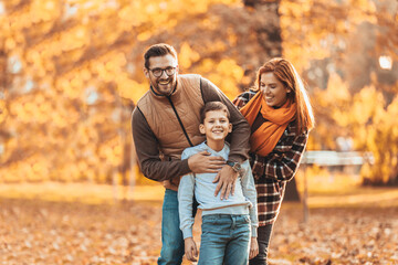 Fototapeta premium Portrait of a happy family having fun in the autumn park.