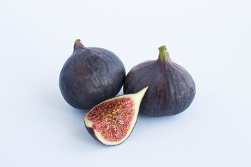 Close-up on ripe blue figs on the white background. Copy space.
