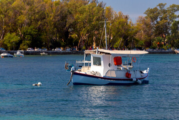 Fototapeta na wymiar Kerkyra. Greece. View of the coastline and fishing boats on a sunny day.