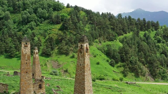 Aerial around view of medieval tower complex in the mountains of Ingushetia, Russia, 4k