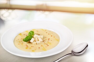 Soup dish with beef and vegetables on a plate on the desk
