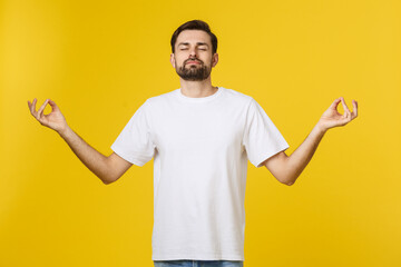 Caucasian young man white t-shirt standing isolated on gray studio background, folding fingers...