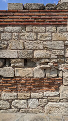 stone wall. red brick and large white stone. fragment of an ancient castle