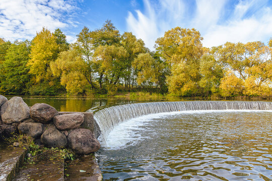 Artificial waterfall in the Drozdy Forest Park in Minsk, Belarus. Autumn landscape.