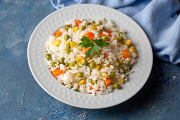 Delicious vegetable rice pilaf with green peas, carrots and sweet corn