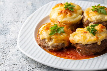 Turkish Food Hasanpasa Kofte - Kofta with Puree - Meatball with Bechamel Sauce and Green Peas. Traditional Food.