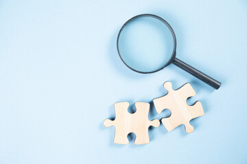 puzzle pieces and a magnifying glass on the table
