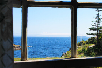 Fototapeta na wymiar View through a window of the coastline and looking beyond, out over the Atlantic Ocean to the horizon.