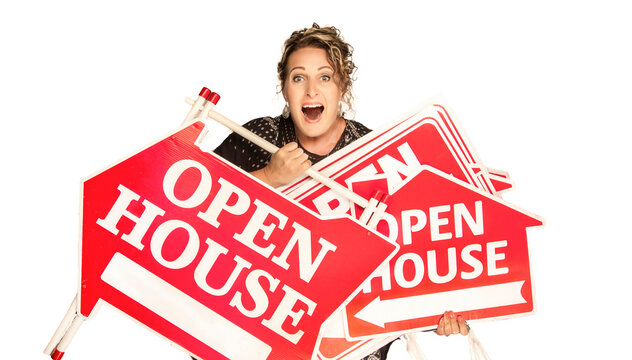 Excited real estate agent holding multiple Open House signs