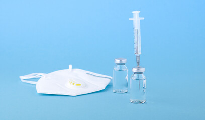 ampoules with Covid-19 vaccine for the fight against coronavirus on a blue background 