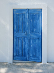 White plaster on the wall. Blue door. Classic Greek combination.