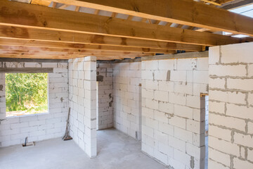 New construction of a residential building under construction. Interior view of the construction of a cottage house