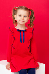 Cute blue eyed girl staring at camera in studio